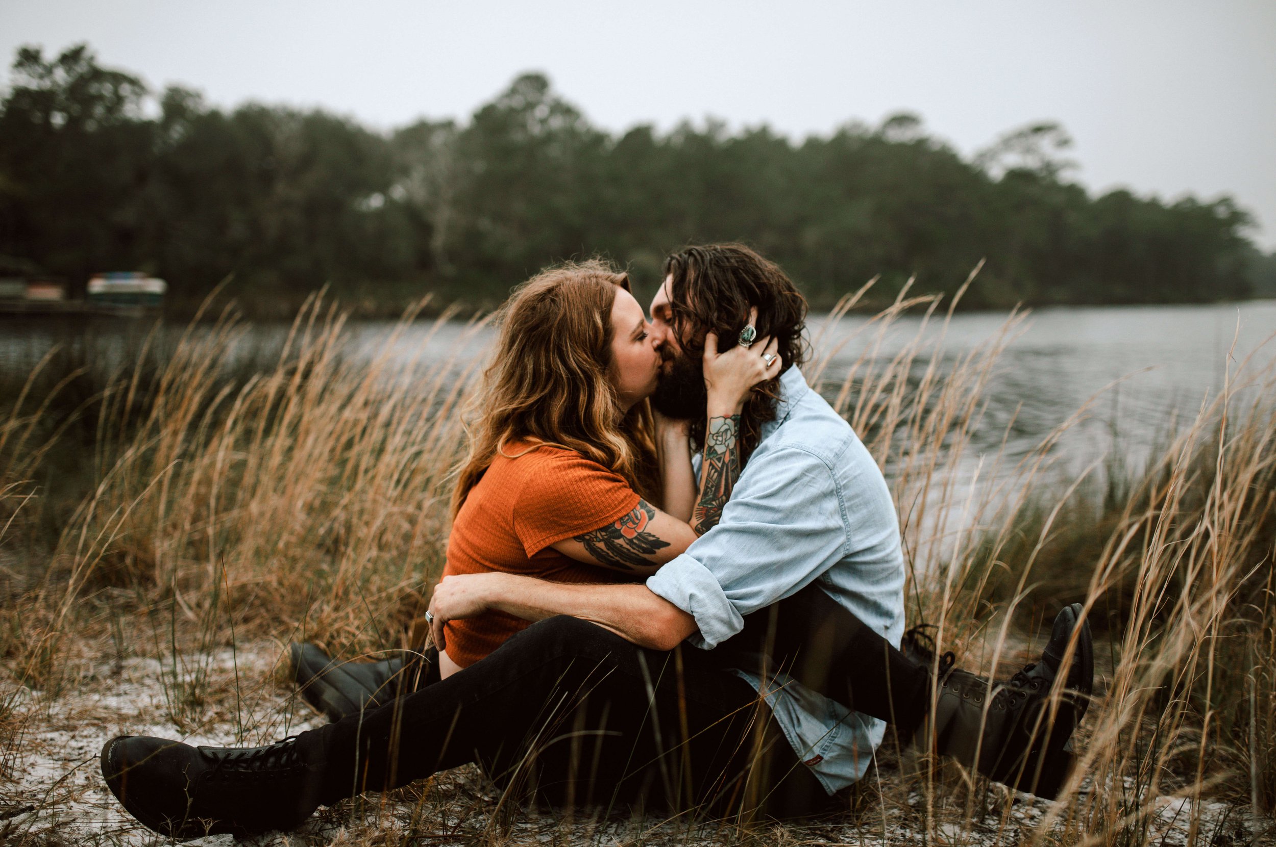 Young couple embracing, sitting on ground by water - photo taken by brittney stanley of be seen photos