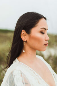 Beachy outdoor close up portrait of bride and her earrings - West PCB, Florida.  Image taken by panama city wedding photographer Brittney Stanley