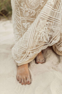 Beach bride feet wearing golden barefoot sandals - Image taken by panama city wedding photographer Brittney Stanley